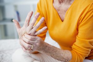 a woman with osteoarthritis in her hand