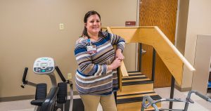Mission Partner poses with model stairs for rehabilitation patients