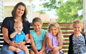Jessica Alward and her family on a porch swing.