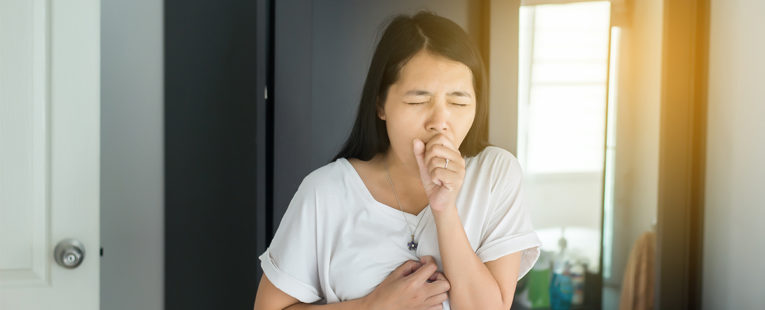 Asian-American woman with pneumonia coughing.