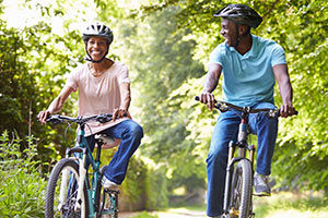 couple riding bicycles in the woods