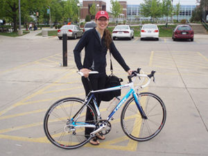 Leann Stickel and bicycle outdoors
