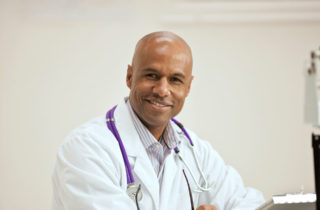 Middle-aged African-American physician in office
