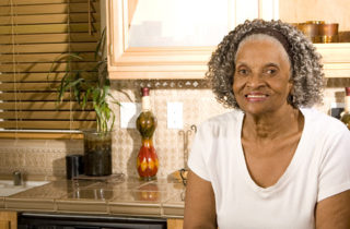 senior African-American woman alone in kitchen