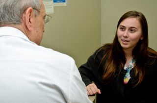 young female patient sharing family history with provider