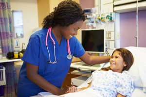 儿科护士握着小女孩病人的手
