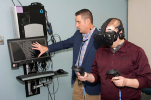Cardiologist and adult congenital heart patient using virtual reality simulator