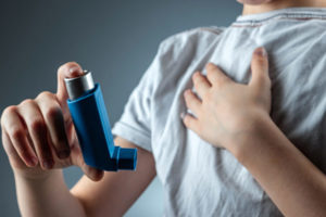 boy with asthma using inhaler