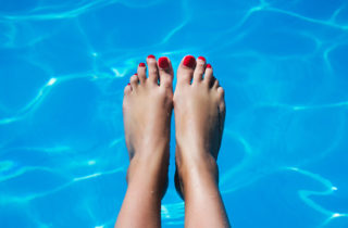 Woman's feet in a pool of water.