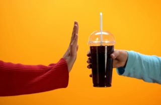 one hand offers another a soda while the other gesture rejection
