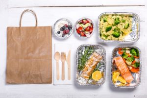 healthy food prepared in carry out boxes ready for a brown bag delivery