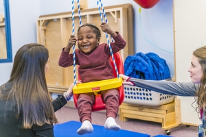 OSF HealthCare pediatric rehabilitation specialist working with child