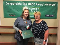 Photo of Amanda Davis, RN, accepting her DAISY Award from Mary Beutke, the patient who nominated her.