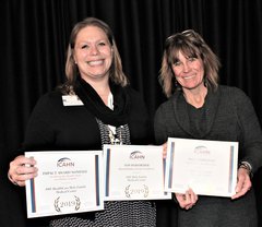 琥珀色的木头, Community Relations Coordinator, for OSF HealthCare Holy Family Medical Center, accepts awards for her hospital’s top performance in quality measures from Angie Charlet, ICAHN’s senior director of Quality, Education, and Compliance.