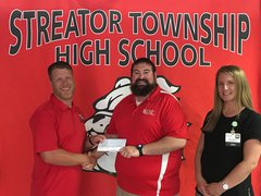 Rory Bedeker, Streator Township High School Athletic Director, accepts a $1,225 donation from OSF HealthCare represented by Brad Yates, Supervisor of Athletic Training, and Megan Brandt, APRN, in Orthopedics.